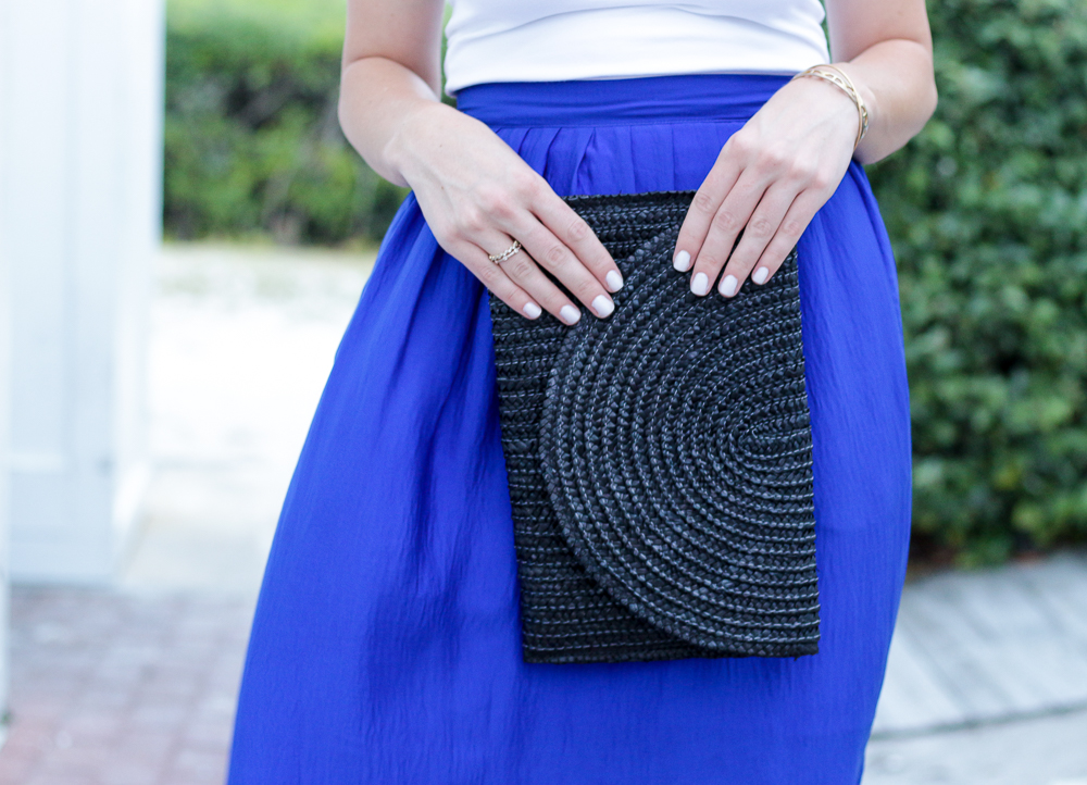 black straw clutch blue maxi skirt boater hat white tank beaded sandals